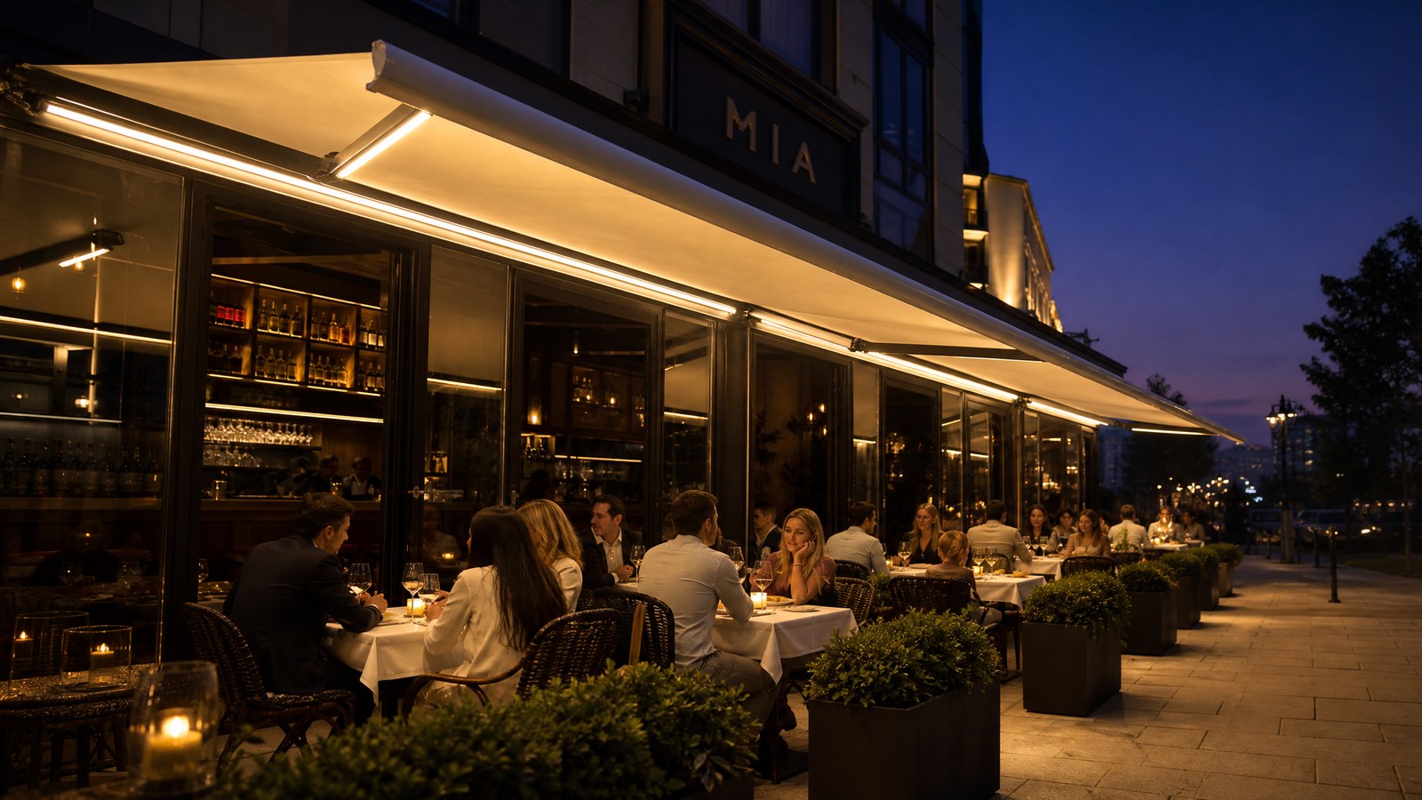Warm LED lighting under retractable awnings in an evening dining setting